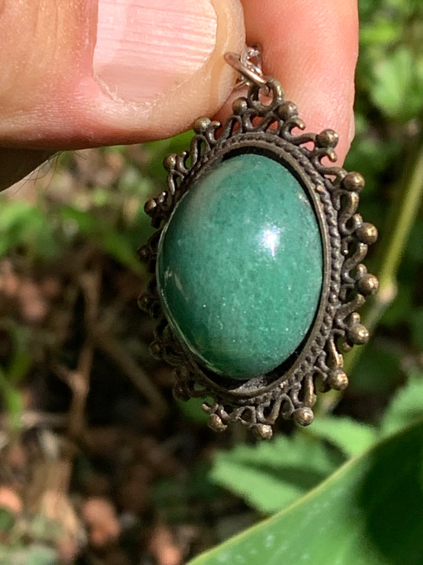 Bronze-colored medallion with Aventurine/green quartz, 36 mm high x 30 x 3. Sold with an adjustable black cord!
