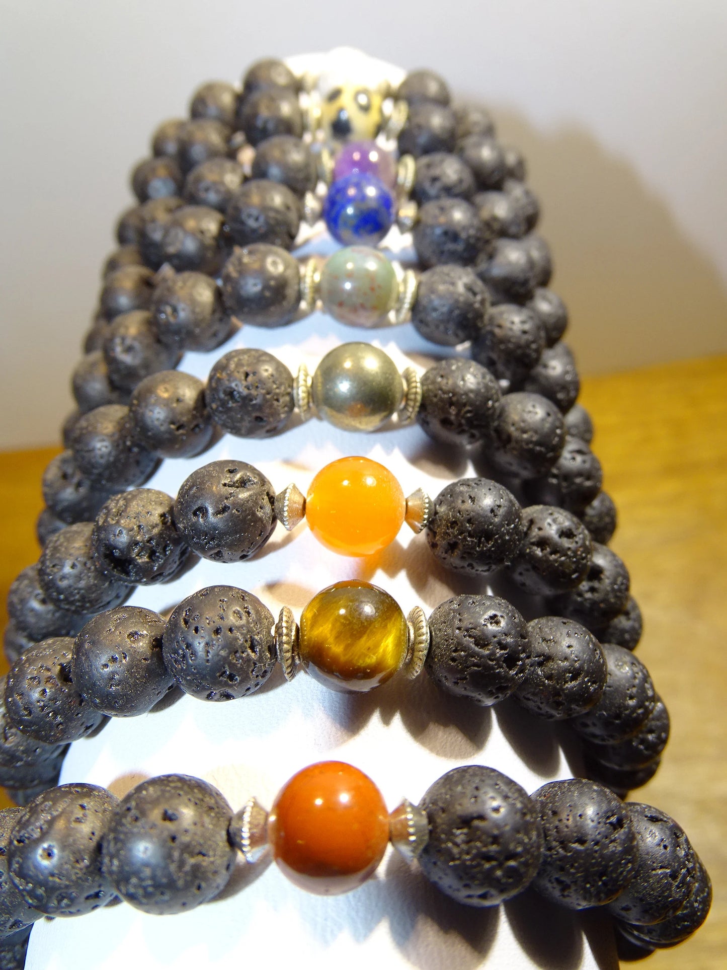 Lava Stone Bracelet Collection... Made from 8mm lava beads and a semi-precious stone bead. Available in lengths from 17 to 21 centimeters. Handmade by Gem & Zen!