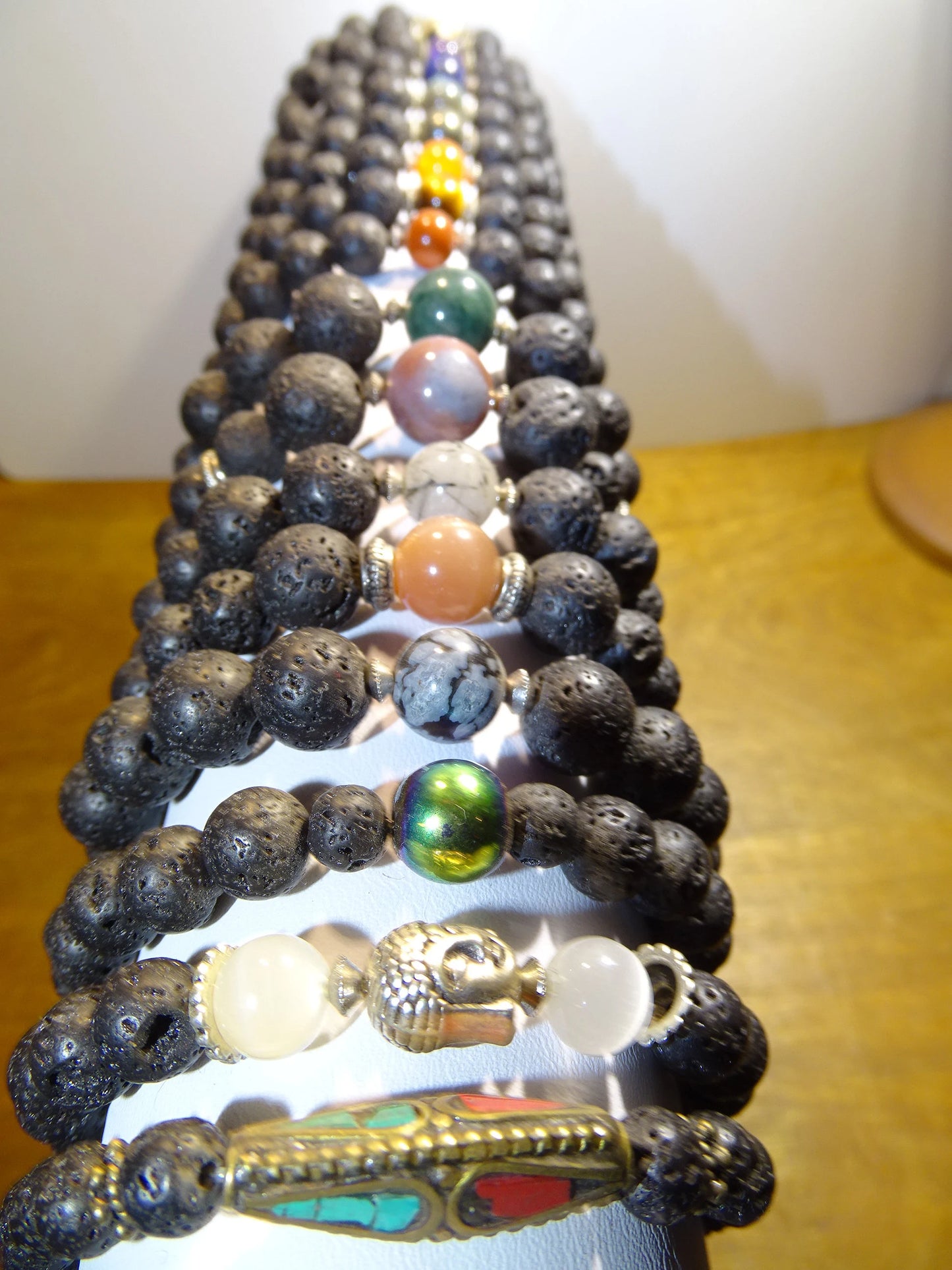 Lava Stone Bracelet Collection... Made from 8mm lava beads and a semi-precious stone bead. Available in lengths from 17 to 21 centimeters. Handmade by Gem & Zen!