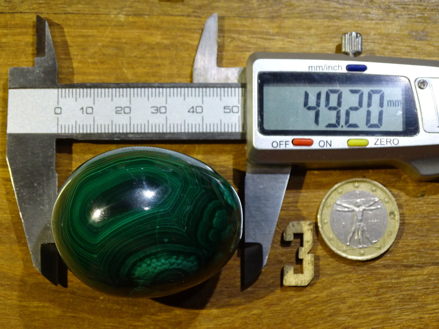 A selection of malachite eggs, weighing from 57 to 177 grams and measuring 35 to 50 millimeters in diameter. High-quality, perfect for lithotherapy, collecting, and displaying!