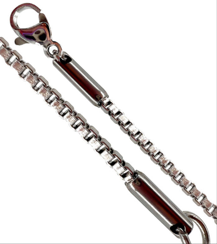 Chaîne à maille carrée est terminée par des embouts en acier intégrés au fermoir et à l’anneau, ce qui renforce la solidité de l'ensemble. Longueur : 50 cm