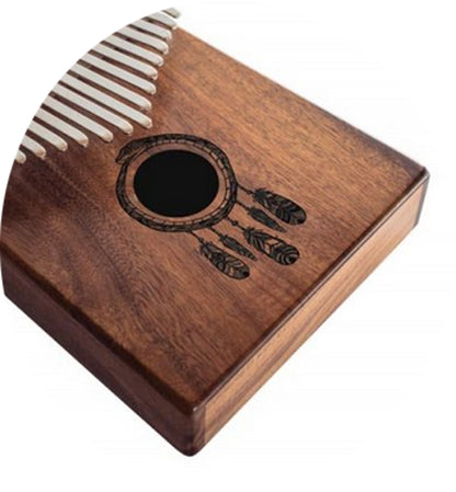 The kalimba or finger piano! 17 notes, made of koa wood (tropical resonance wood) in the key of C major. Decorated with a carved Indian motif and comes with a cloth bag and a tuning hammer! 23x19x7.5 cm!