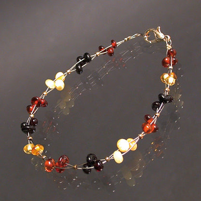 Amber, 6 millimeter bead bracelet on 3 twisted strands, 18 centimeters long. With 'omard' clasp, very beautiful creation!