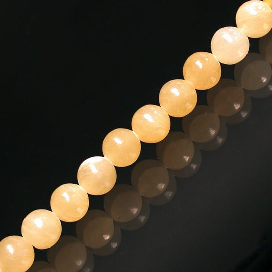 Calcite Orange, perles rondes de 6 ou 8 mm. Vendu en fil de perle 38/39 cm, en bracelet de 17 à 21cm, en collier de 45 ou sautoir de 60cm. Qualité AA à AAA, superbes perles !