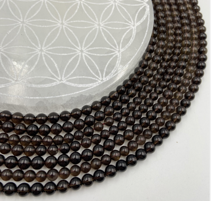 Cristal de roche fumé/ Quartz Fumé, perles rondes de 6 ou 8 mm. Vendu en fil de perle 38/39 cm, en bracelet de 17 à 21cm, en collier de 45 ou sautoir de 60cm. Qualité AA à AAA !
