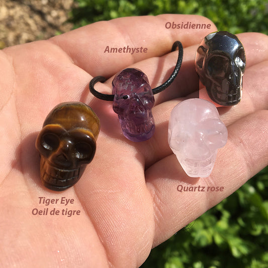 Pendentif en forme de crâne, symbole de la connaissance ! De 18 millimètres de hauteur x 16 mm de largeur. Pierre au choix : Améthyste, Obsidienne, Quartz rose, Oeil de tigre. Vendu avec cordon noir réglable offert, parfait !