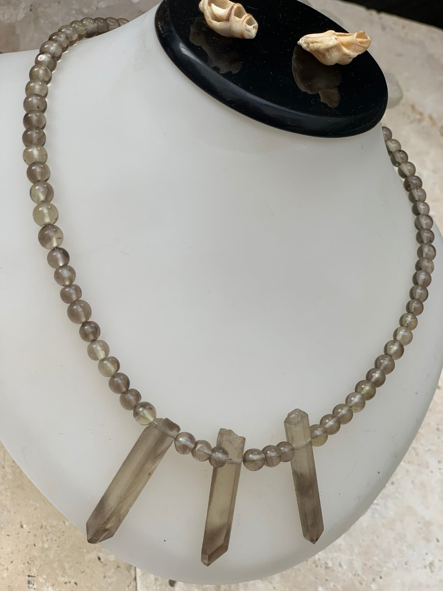 Cristal de roche/ Quartz fumé, en collier de 42 centimètres. Perle rondes de 4 à 7 millimètres avec 3 cristaux naturels en panoramique, fermoir de type 'crochet' !