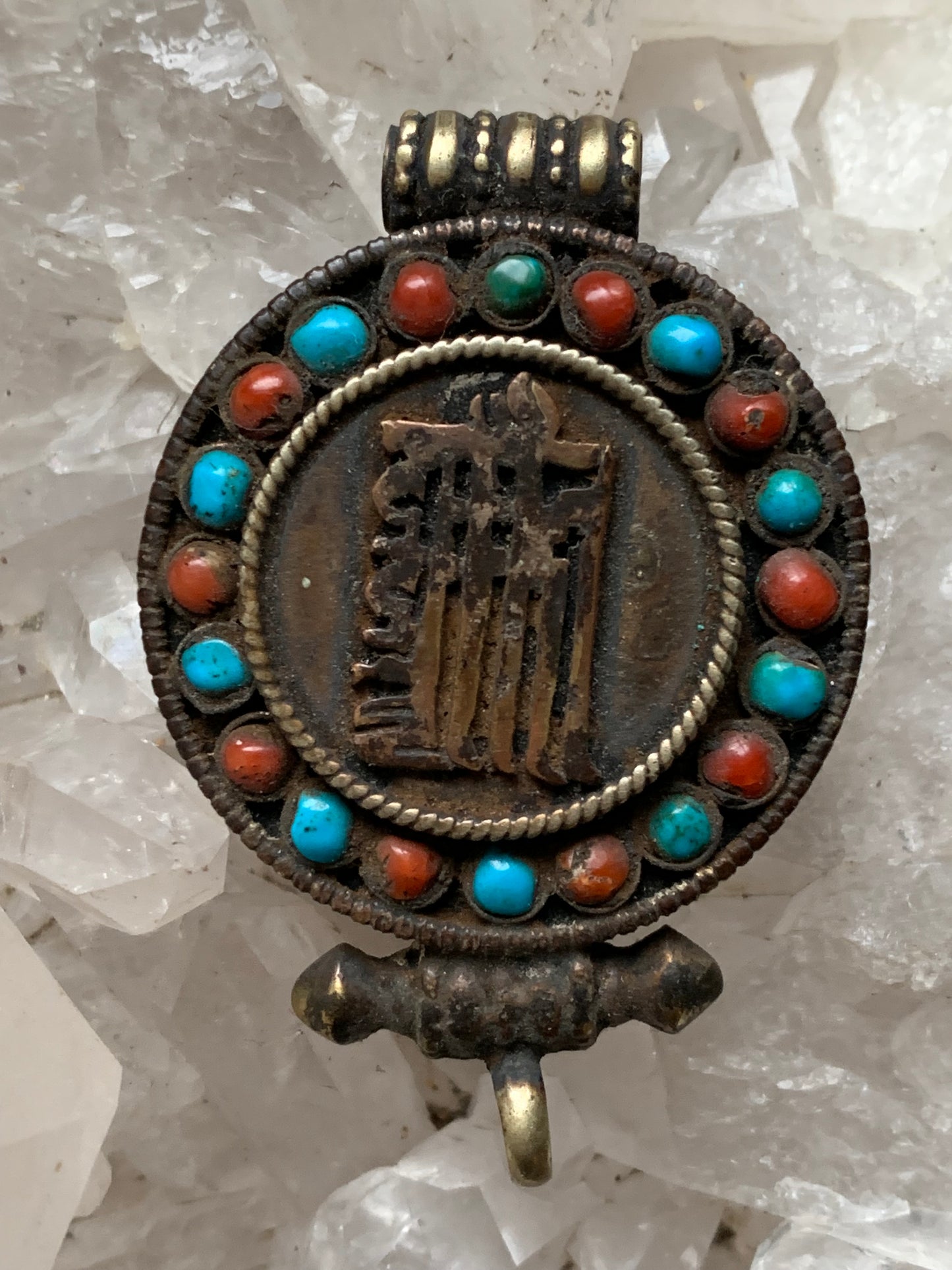 Handcrafted pendant/reliquary from Nepal with turquoise and coral stones set on metal with a beautiful Om engraving! 52 millimeters high x 35 mm wide x 11 mm thick. Sold with a free adjustable black cord, perfect!