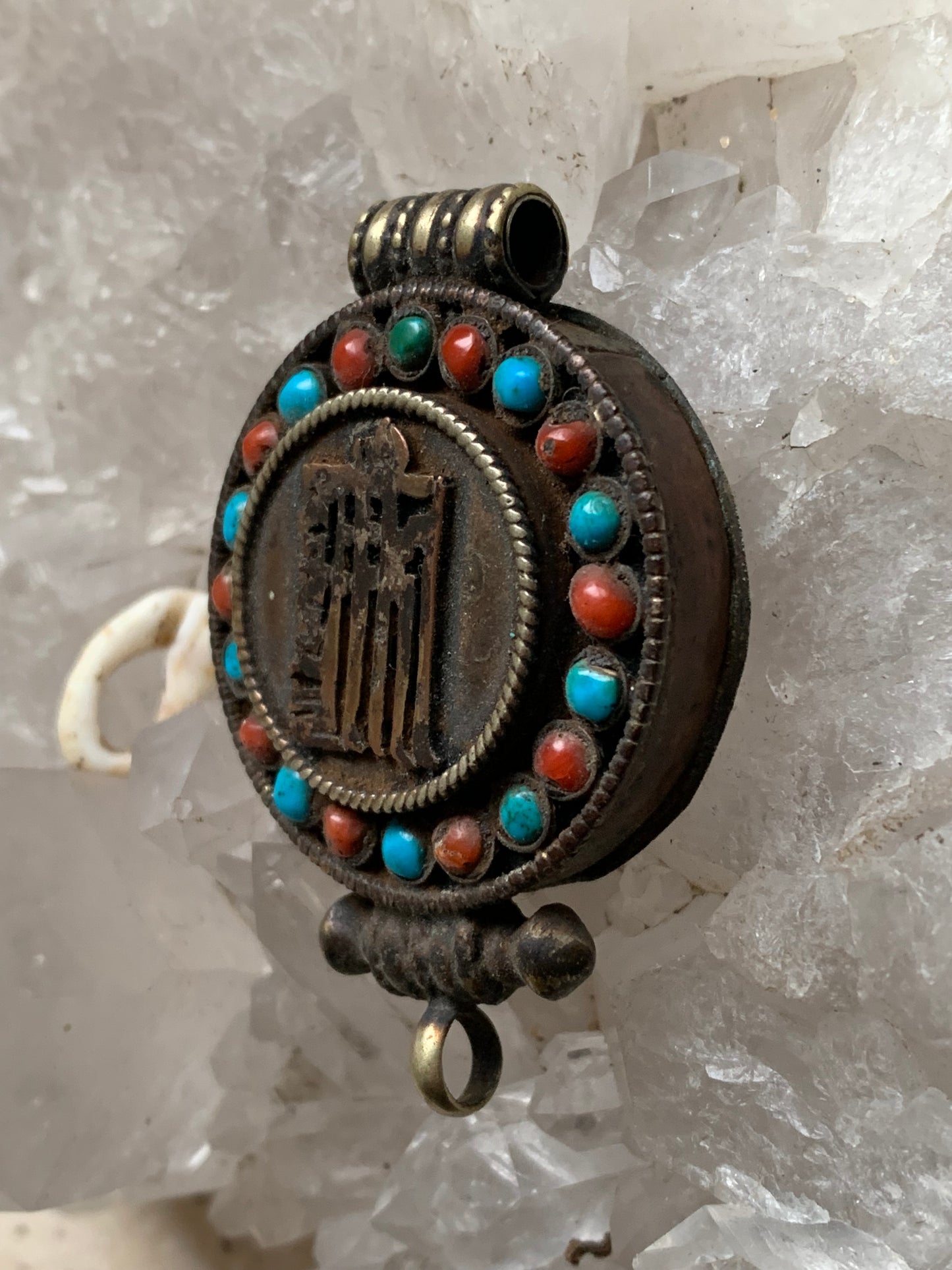 Handcrafted pendant/reliquary from Nepal with turquoise and coral stones set on metal with a beautiful Om engraving! 52 millimeters high x 35 mm wide x 11 mm thick. Sold with a free adjustable black cord, perfect!