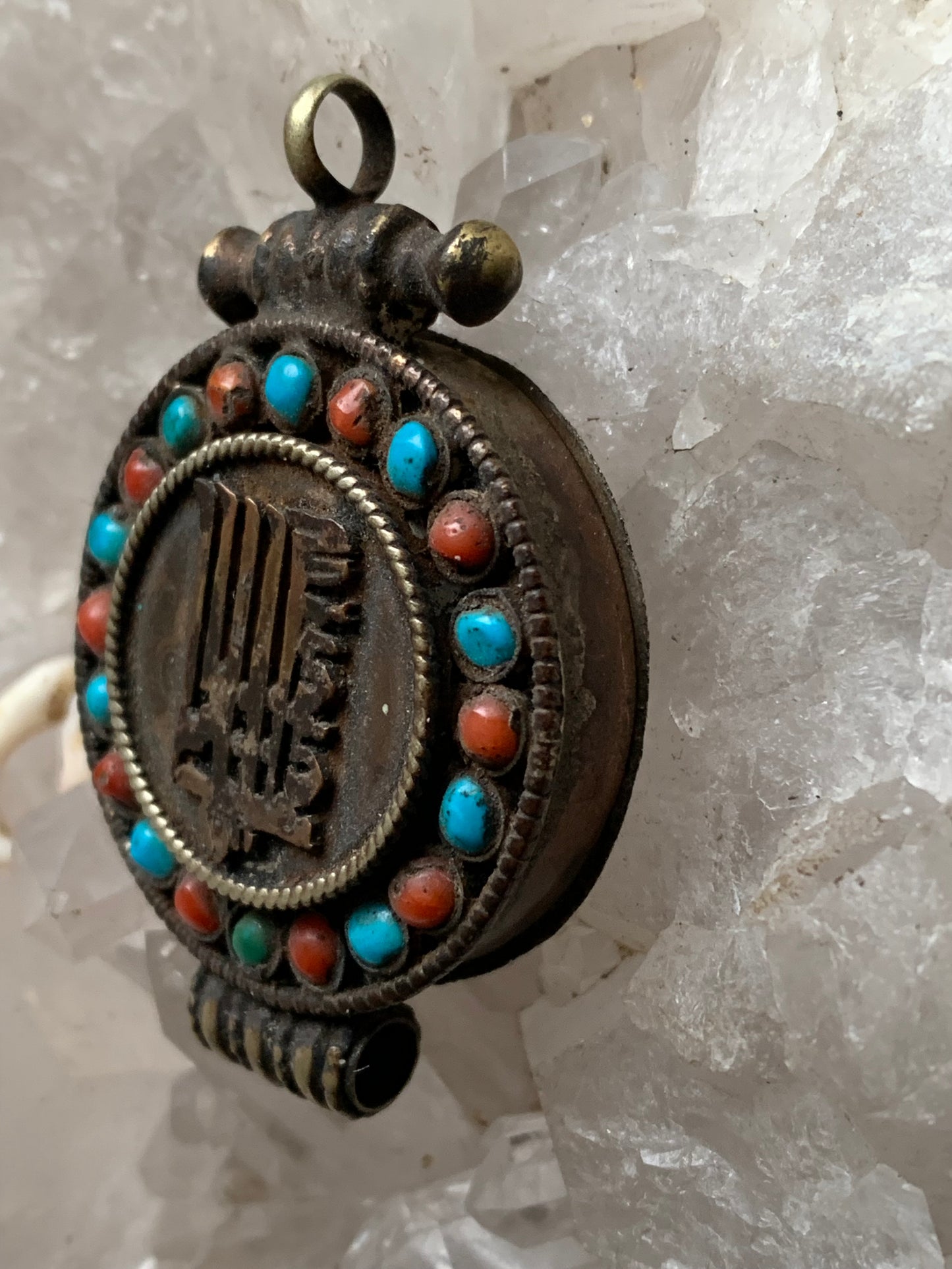 Handcrafted pendant/reliquary from Nepal with turquoise and coral stones set on metal with a beautiful Om engraving! 52 millimeters high x 35 mm wide x 11 mm thick. Sold with a free adjustable black cord, perfect!