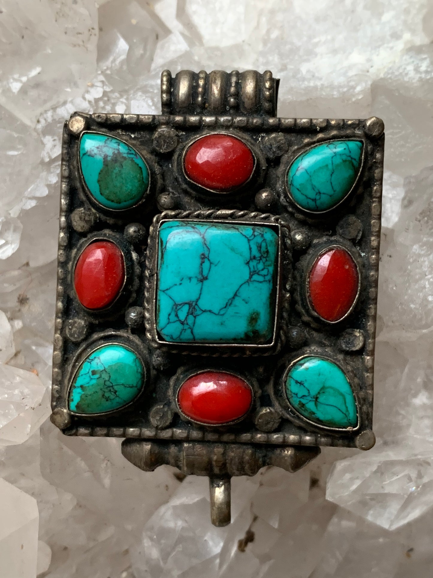 Pendentif/ Reliquaire artisanal du Népal avec pierres de turquoise et de corail sertis sur méta ! De 50 millimètres de hauteur x 35 mm de largeur x 17 d'épaisseur. Vendu avec cordon noir réglable offert, parfait !