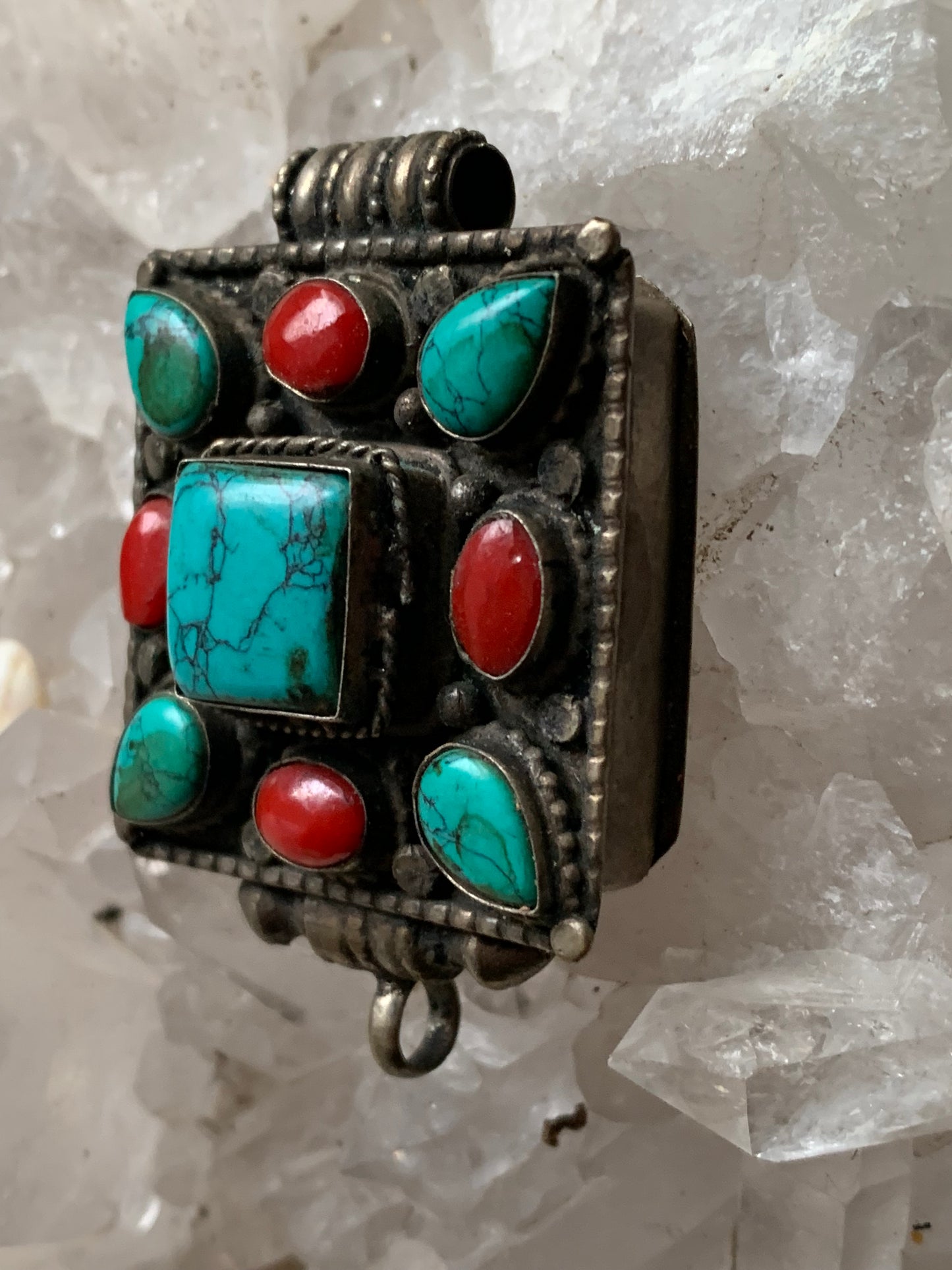 Pendentif/ Reliquaire artisanal du Népal avec pierres de turquoise et de corail sertis sur méta ! De 50 millimètres de hauteur x 35 mm de largeur x 17 d'épaisseur. Vendu avec cordon noir réglable offert, parfait !