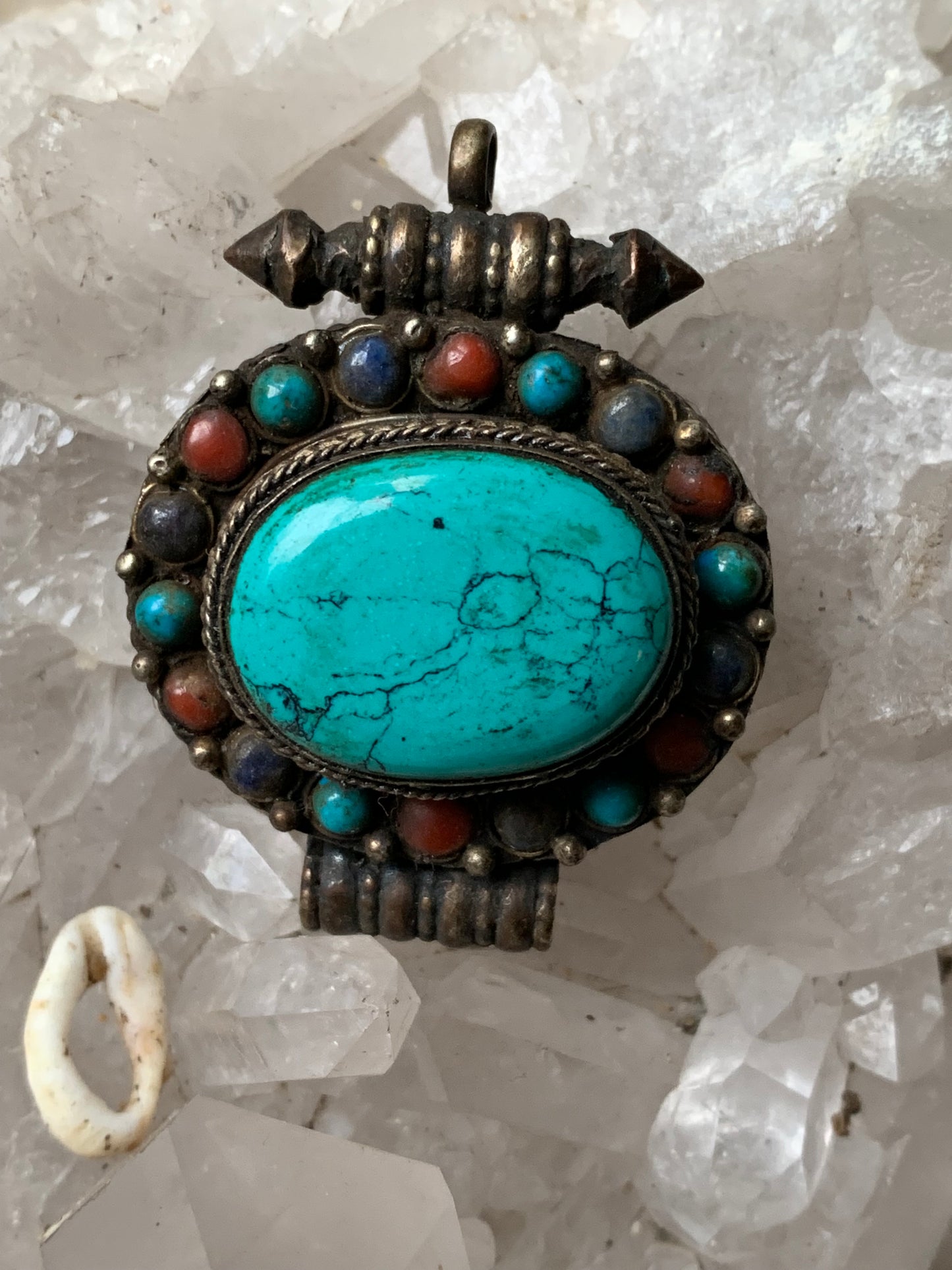 Handcrafted pendant/reliquary from Nepal with turquoise and coral stones set in metal! 48 millimeters high x 37 mm wide x 18 mm thick. Sold with a free adjustable black cord, perfect!