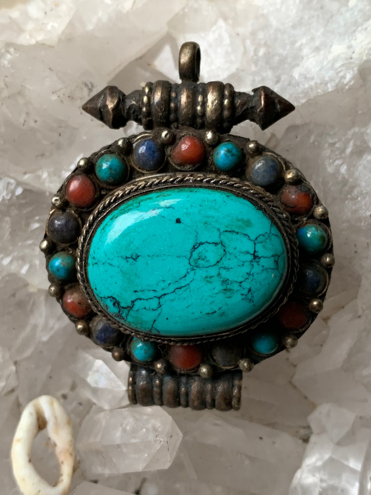 Handcrafted pendant/reliquary from Nepal with turquoise and coral stones set in metal! 48 millimeters high x 37 mm wide x 18 mm thick. Sold with a free adjustable black cord, perfect!