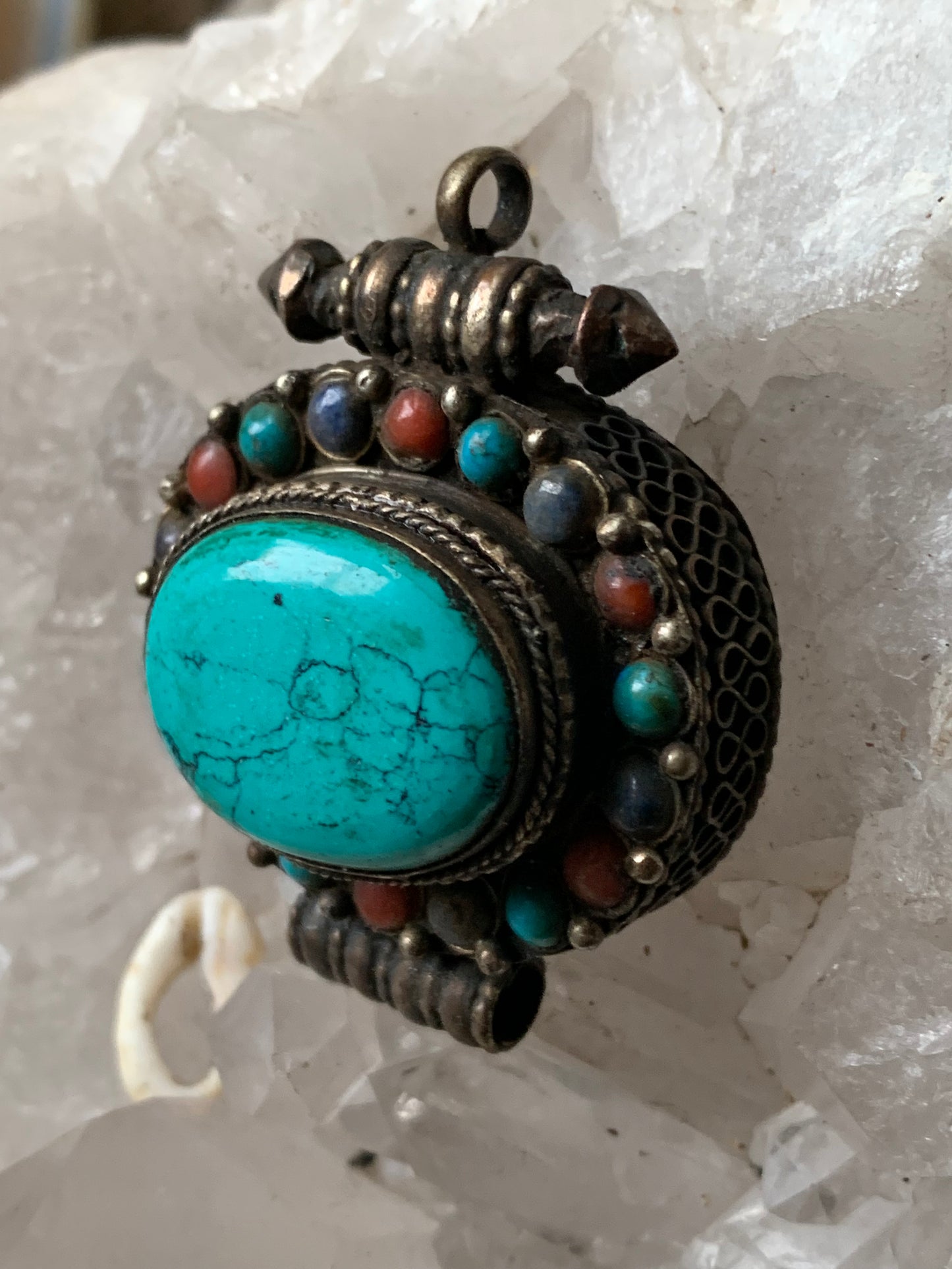 Handcrafted pendant/reliquary from Nepal with turquoise and coral stones set in metal! 48 millimeters high x 37 mm wide x 18 mm thick. Sold with a free adjustable black cord, perfect!
