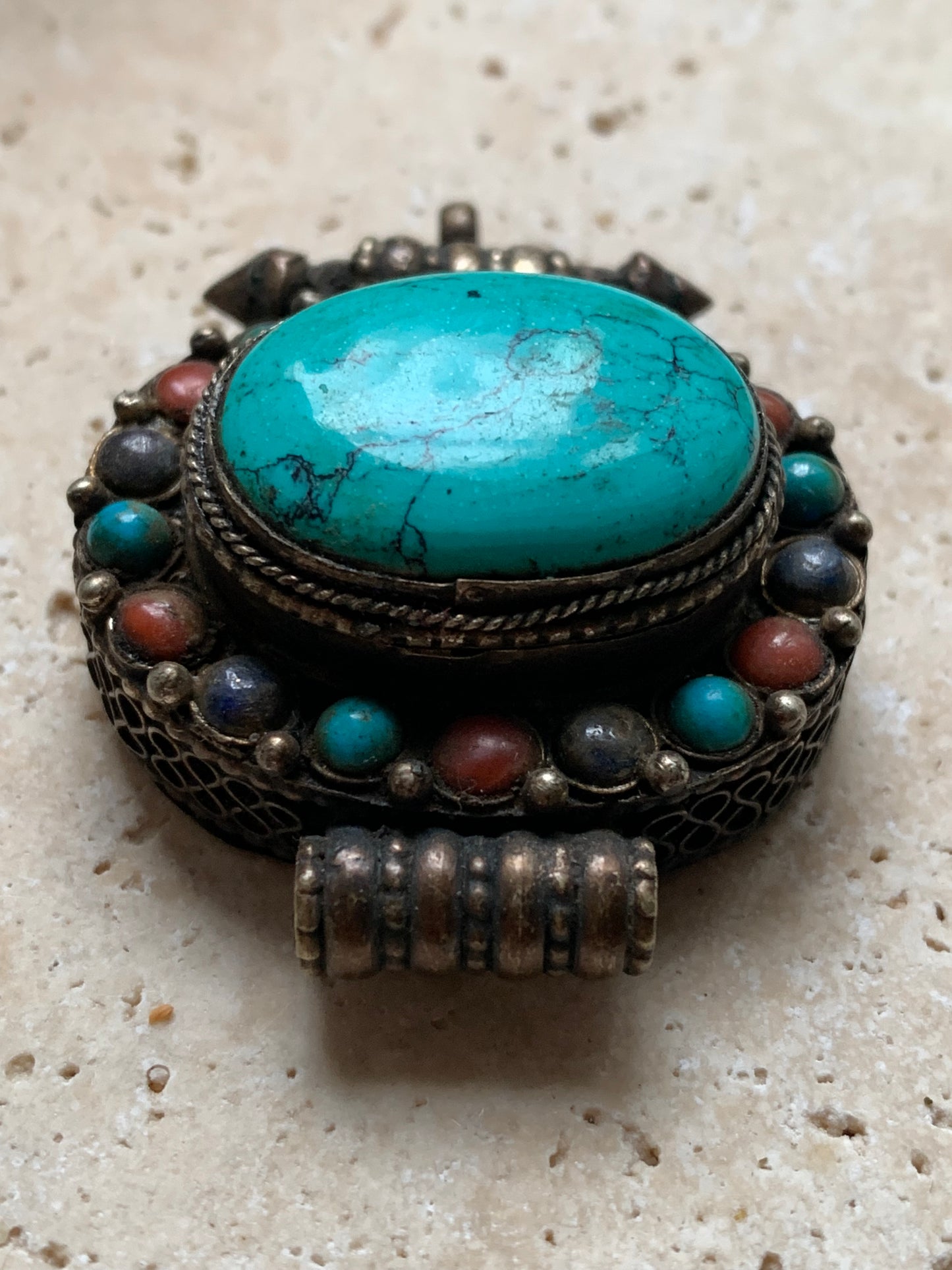 Handcrafted pendant/reliquary from Nepal with turquoise and coral stones set in metal! 48 millimeters high x 37 mm wide x 18 mm thick. Sold with a free adjustable black cord, perfect!