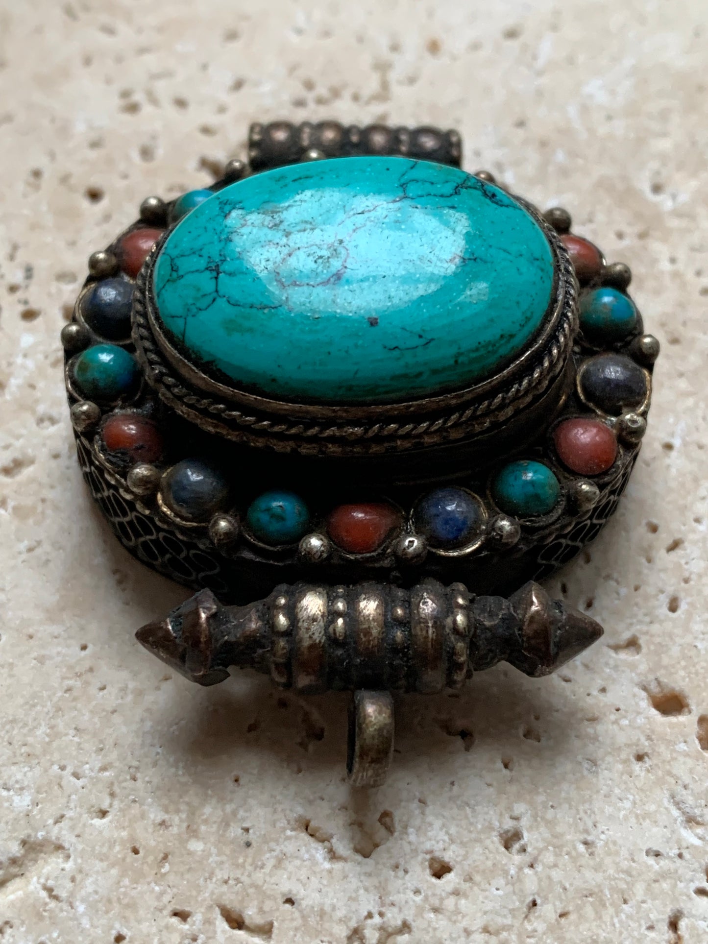 Handcrafted pendant/reliquary from Nepal with turquoise and coral stones set in metal! 48 millimeters high x 37 mm wide x 18 mm thick. Sold with a free adjustable black cord, perfect!