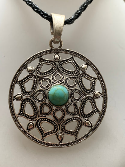 Pendentif en métal argenté en forme de Mandala avec cabochon d'howlite bleue au centre. De 48 x 12 millimètres. Vendu avec cordon noir réglable offert, parfait !