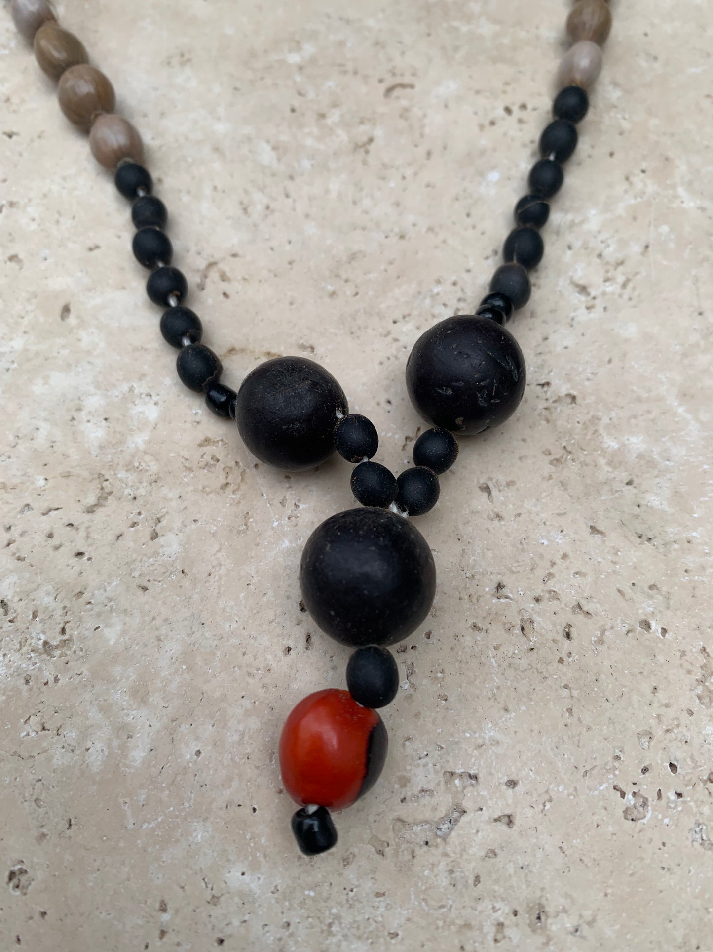 Collier du Pérou en graines naturelles, perles de ± 8 à 12 millimètres. Taille de 60 centimètres de longueur environ + pendentif de 30 mm(coque). Superbe pièce !