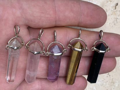 Pendentifs de cristaux 'laser' à pointe biterminée avec attache articulée, au choix : Cristal, quartz rose, améthyste, obsidienne, oeil de tigre ! De 37 millimètres x 8 millimètres de diamètre. Vendu avec cordon réglable de couleur noire !