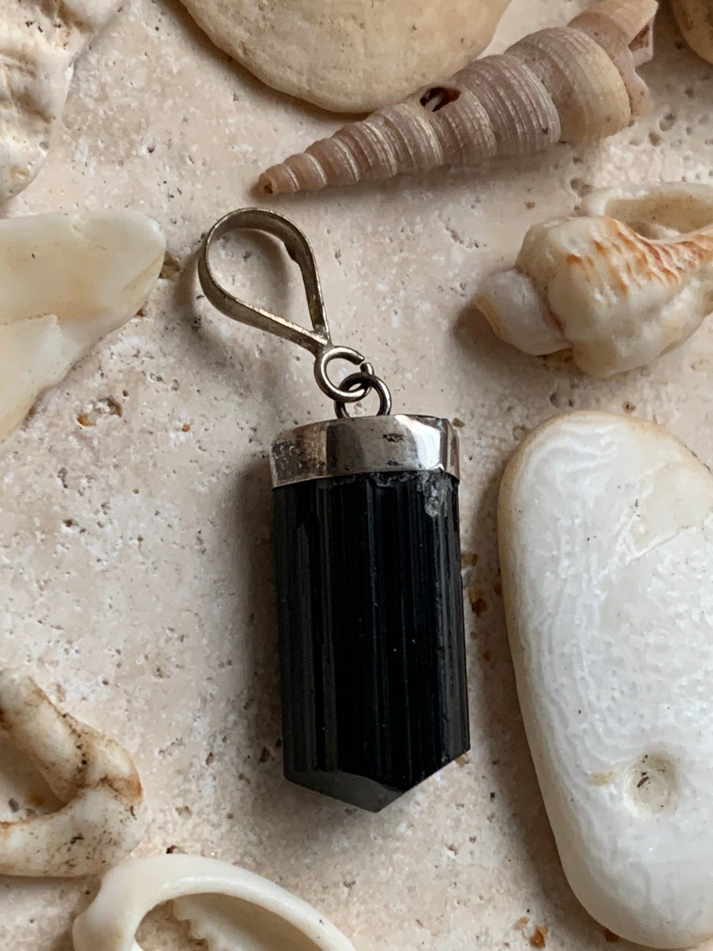 Aquamarine pendant set in silver with a metal design! Unique piece measuring 38 millimeters high x 12 millimeters wide x 8 millimeters thick. Sold with an adjustable black cord. Made in Pakistan!