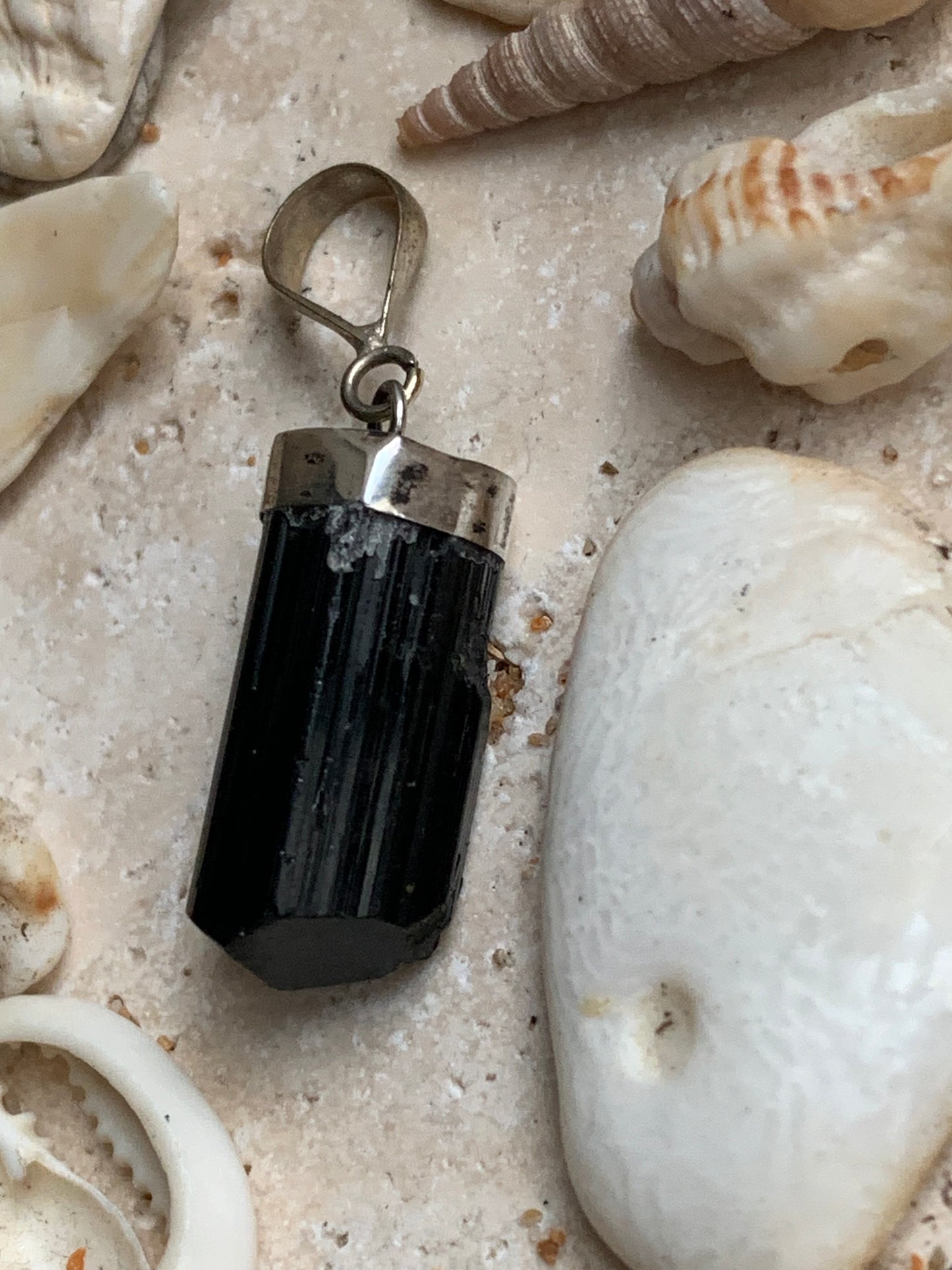 Aquamarine pendant set in silver with a metal design! Unique piece measuring 38 millimeters high x 12 millimeters wide x 8 millimeters thick. Sold with an adjustable black cord. Made in Pakistan!
