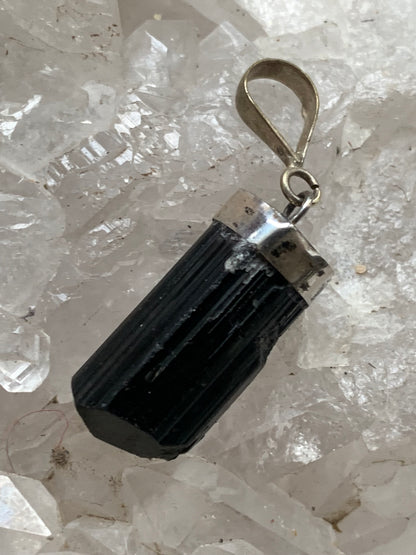 Aquamarine pendant set in silver with a metal design! Unique piece measuring 38 millimeters high x 12 millimeters wide x 8 millimeters thick. Sold with an adjustable black cord. Made in Pakistan!