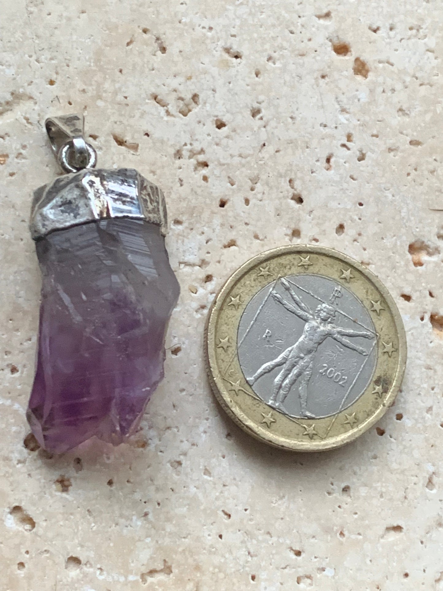 Aquamarine pendant set in silver with a metal design! Unique piece measuring 38 millimeters high x 12 millimeters wide x 8 millimeters thick. Sold with an adjustable black cord. Made in Pakistan!
