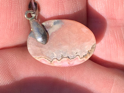 Rhodochrosite, 'cabochon percé' de 37 mm x 17 x 6. Vendu avec un cordon réglable de couleur noire !