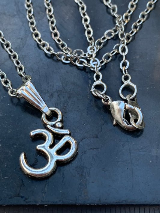 Om, pendentif en laiton argenté, de 23x12x2 millimètres -1,3 gr. Vendu avec cordon noir réglable offert, parfait !