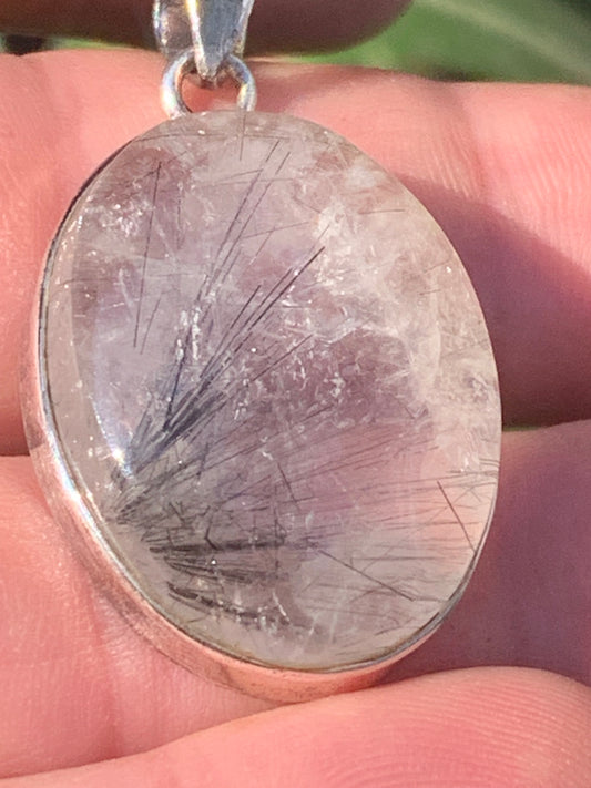 Rock crystal/quartz with black tourmaline inclusions! Silver pendant, 43 mm high x 25 mm wide x 10 mm thick. Sold with an adjustable black cord!