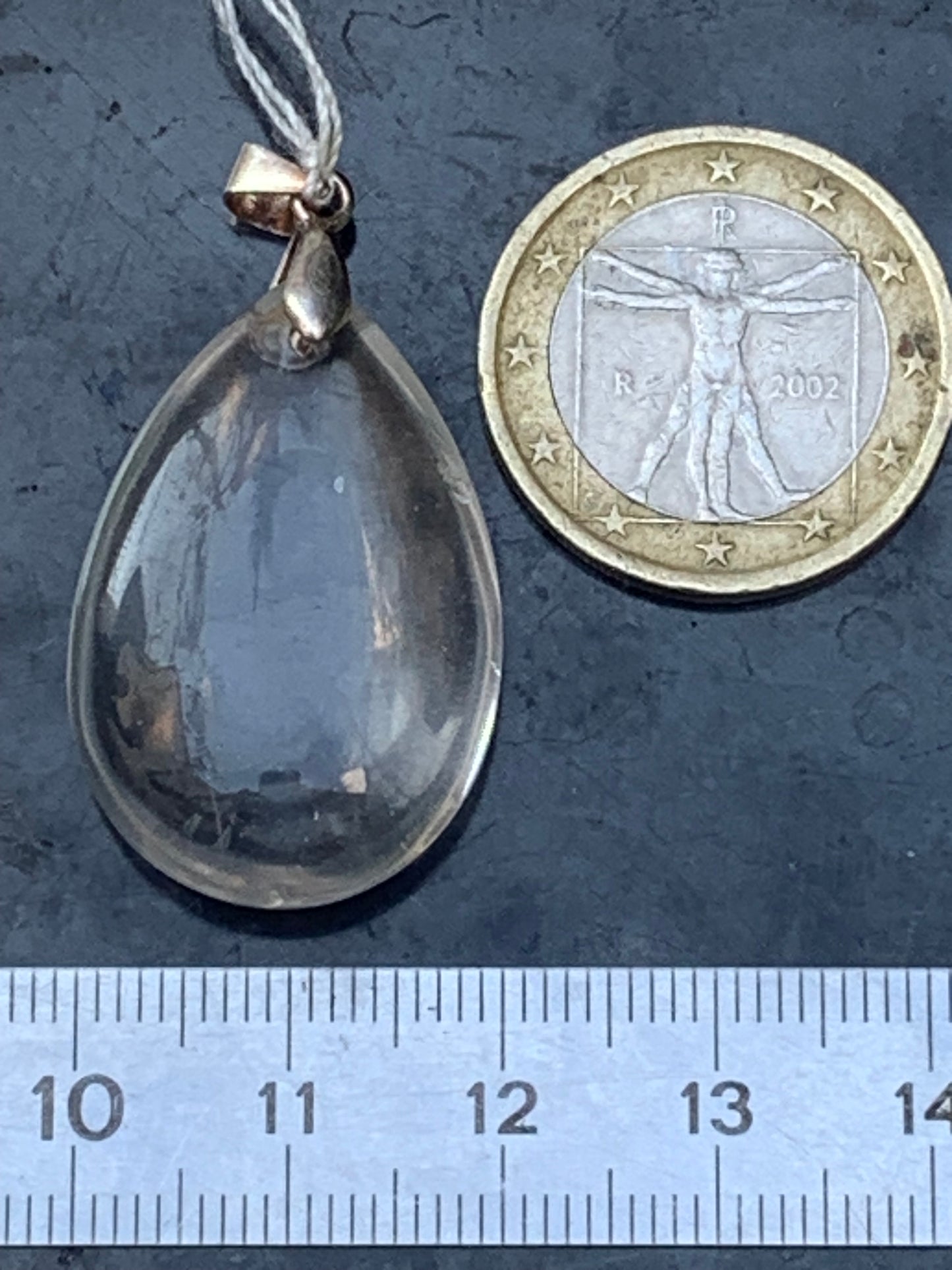 Rock crystal/quartz, AAA quality silver 'drop' pendant, 40mm high x 20mm wide x 9mm thick. Sold with an adjustable black cord! A crystal jewel, for those who love to walk between light and mystery!