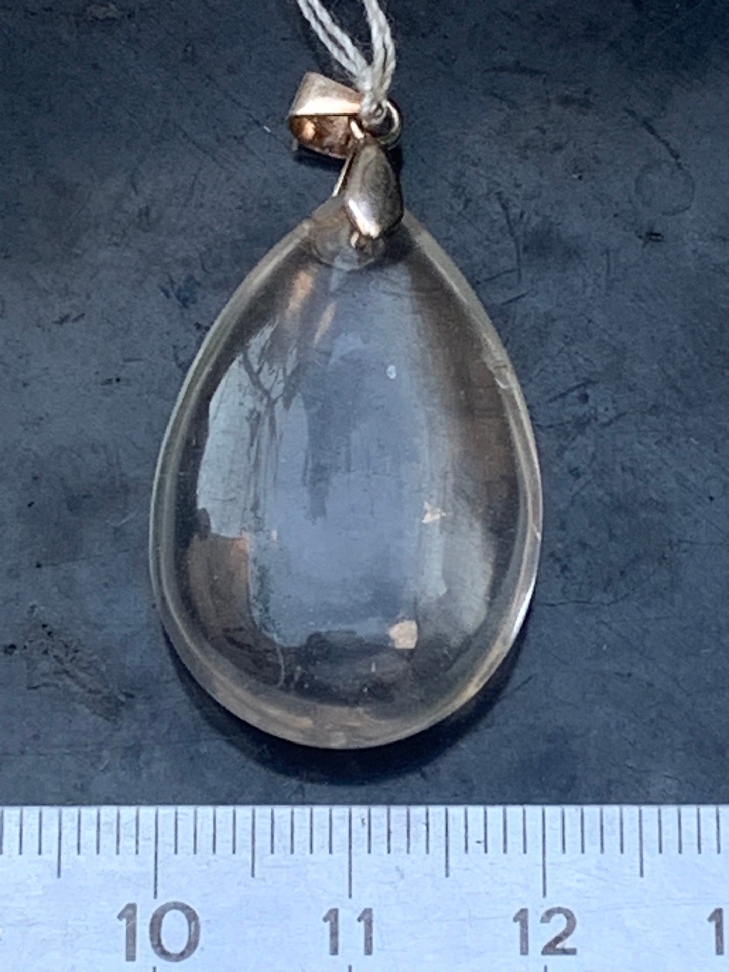 Rock crystal/quartz, AAA quality silver 'drop' pendant, 40mm high x 20mm wide x 9mm thick. Sold with an adjustable black cord! A crystal jewel, for those who love to walk between light and mystery!