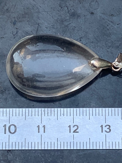 Rock crystal/quartz, AAA quality silver 'drop' pendant, 40mm high x 20mm wide x 9mm thick. Sold with an adjustable black cord! A crystal jewel, for those who love to walk between light and mystery!
