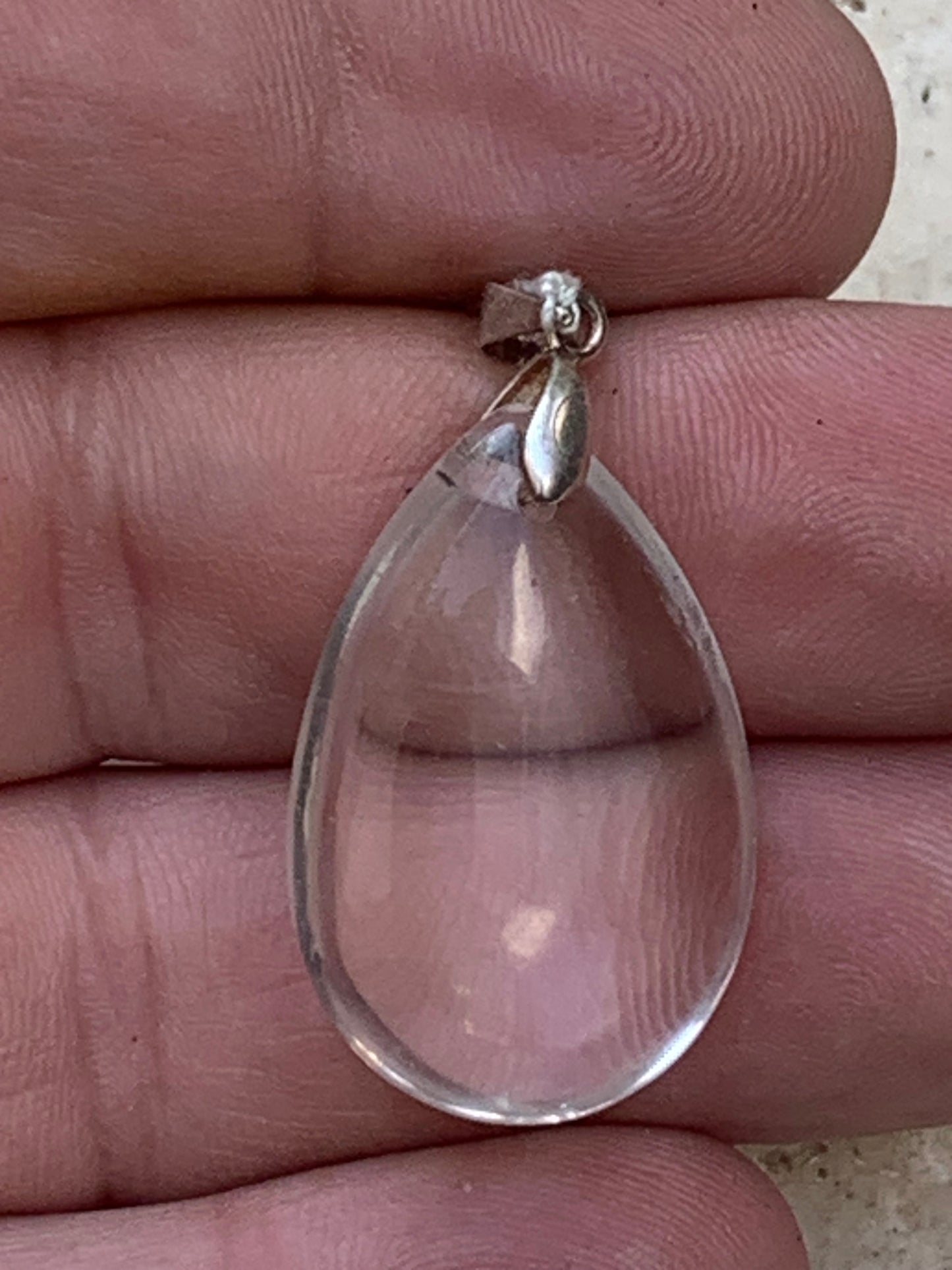 Rock crystal/quartz, AAA quality silver 'drop' pendant, 40mm high x 20mm wide x 9mm thick. Sold with an adjustable black cord! A crystal jewel, for those who love to walk between light and mystery!