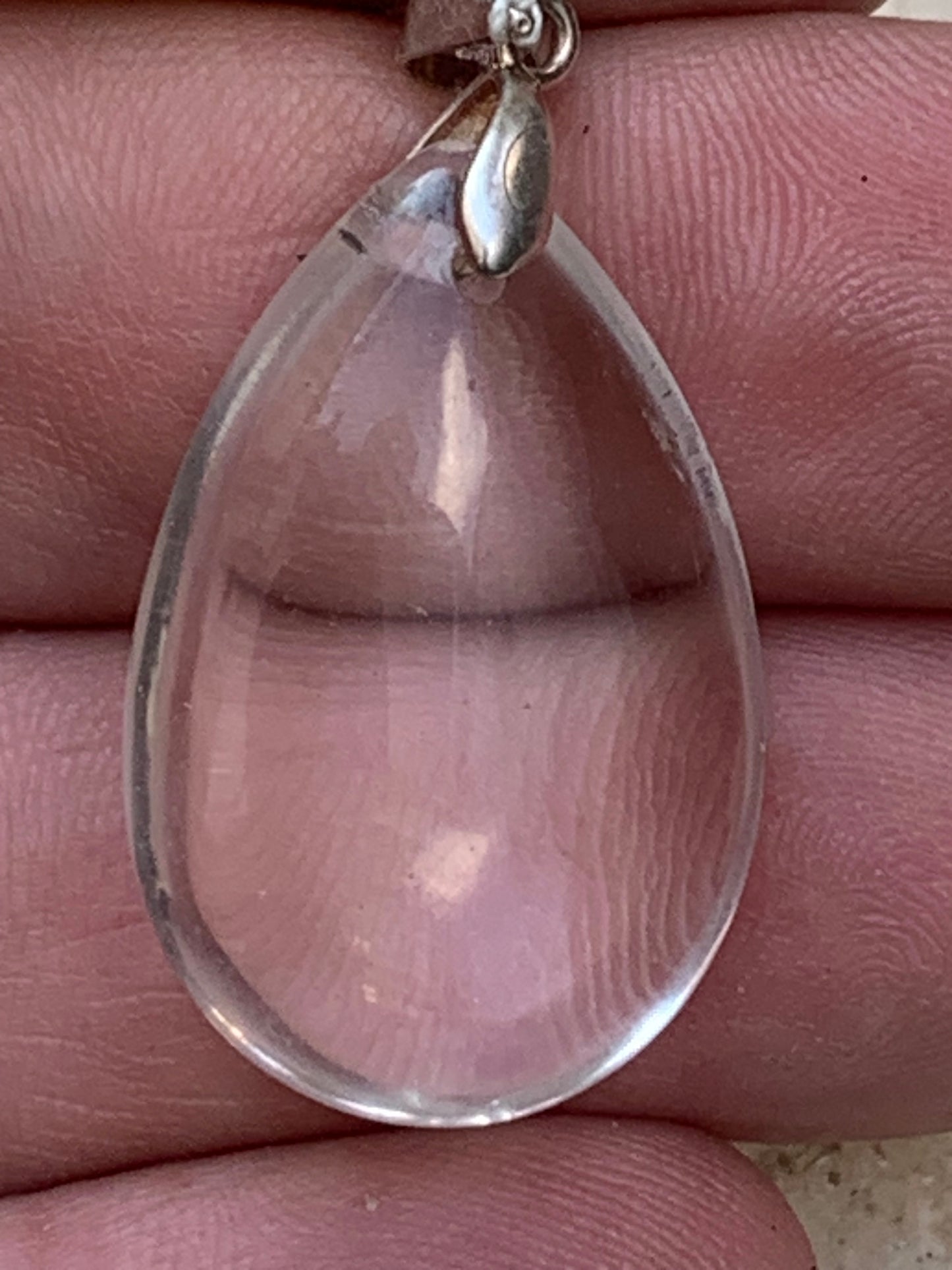Rock crystal/quartz, AAA quality silver 'drop' pendant, 40mm high x 20mm wide x 9mm thick. Sold with an adjustable black cord! A crystal jewel, for those who love to walk between light and mystery!