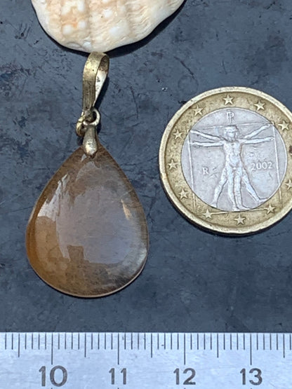 Rock crystal/quartz with golden rutile inclusions! Silver pendant, 40 mm high x 20 mm wide x 5 mm thick. Sold with an adjustable black cord!