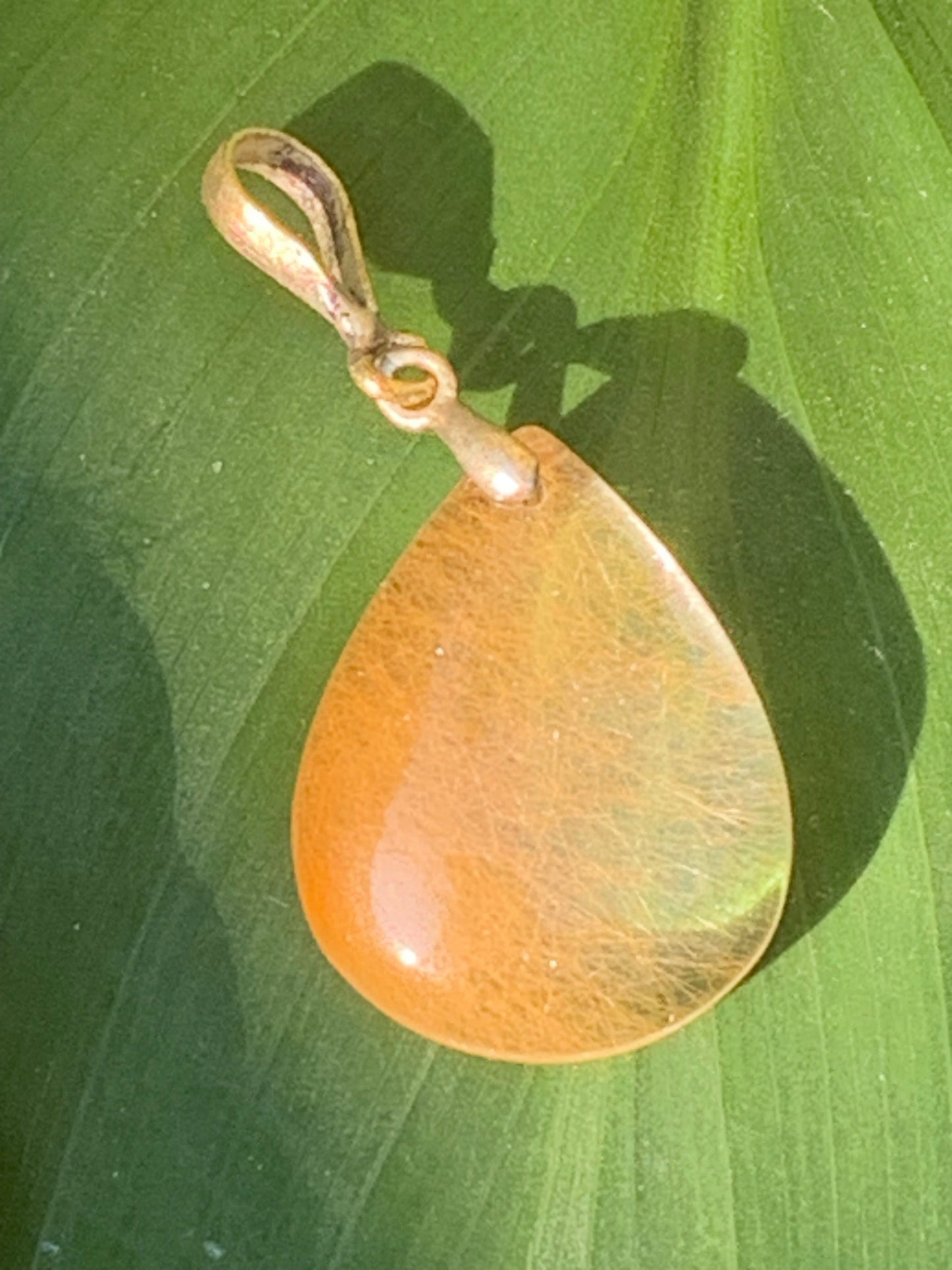 Rock crystal/quartz with golden rutile inclusions! Silver pendant, 40 mm high x 20 mm wide x 5 mm thick. Sold with an adjustable black cord!