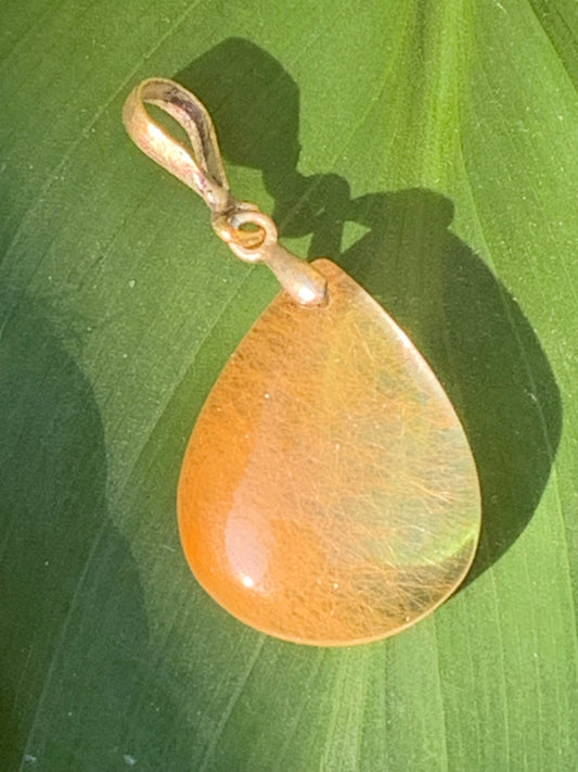 Rock crystal/quartz with golden rutile inclusions! Silver pendant, 40 mm high x 20 mm wide x 5 mm thick. Sold with an adjustable black cord!