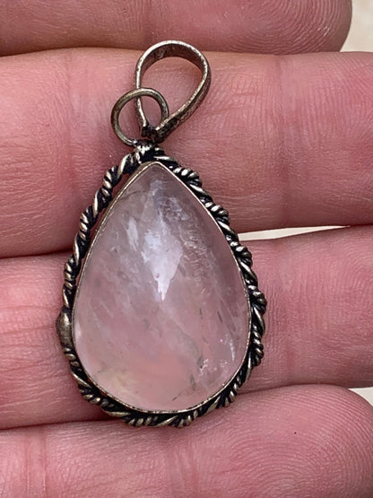 Rock crystal/Rose quartz! Pendant measuring 44mm high x 23mm wide x 12mm thick. Sold with an adjustable black cord!
