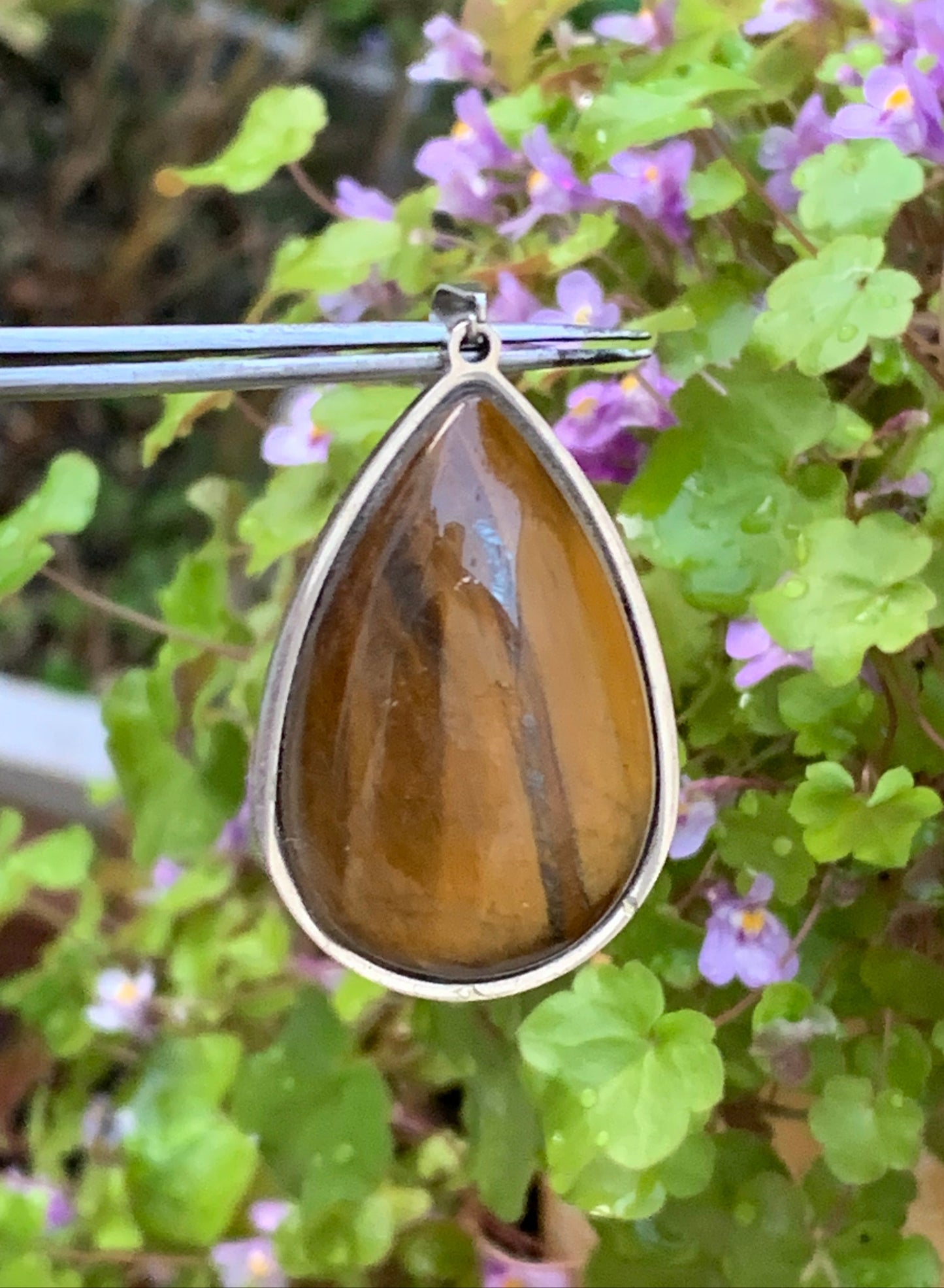 Tiger's Eye, pendant measuring 45mm high x 25mm wide x 8mm thick. Sold with a free adjustable black cord!