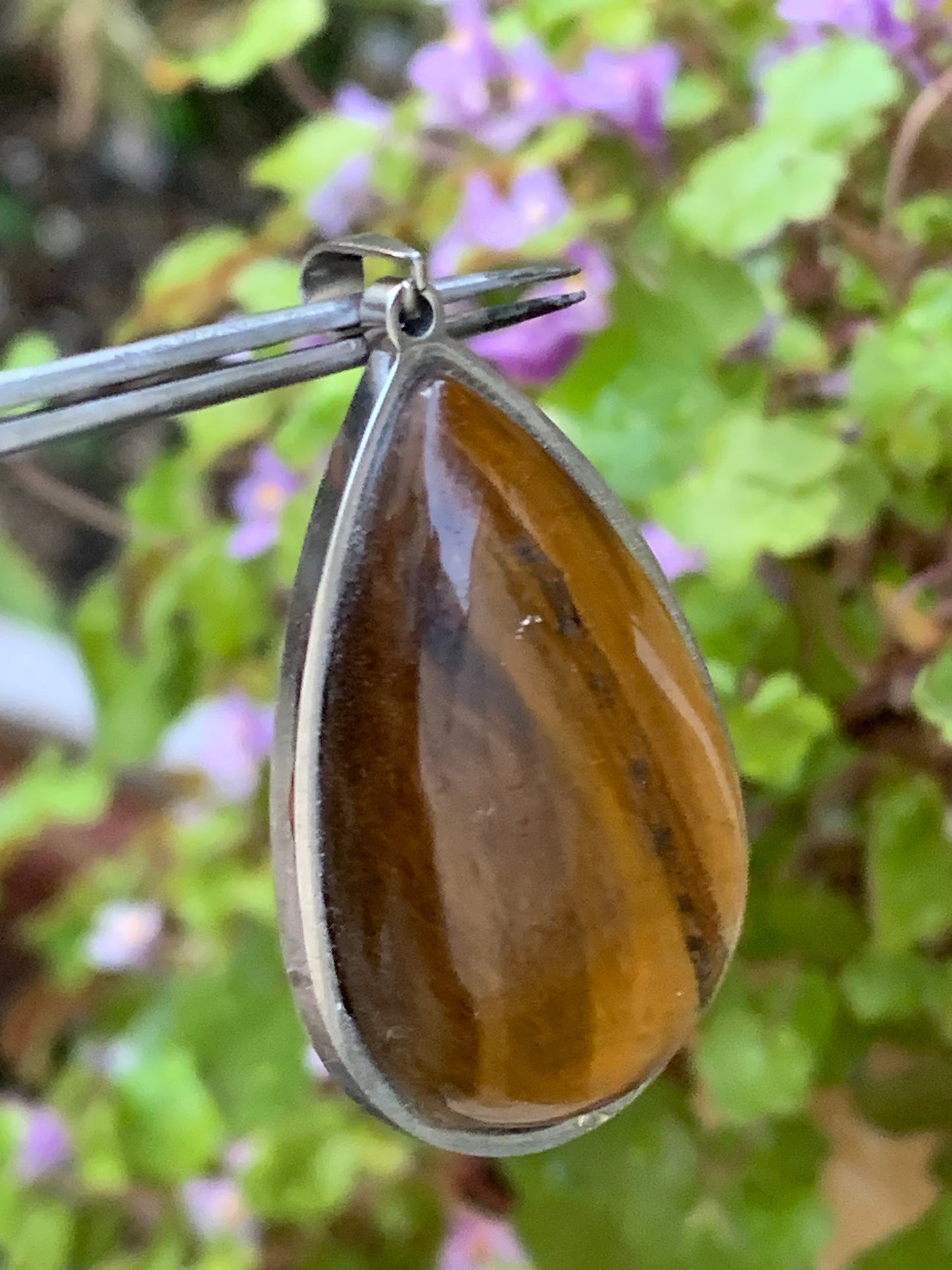 Tiger's Eye, pendant measuring 45mm high x 25mm wide x 8mm thick. Sold with a free adjustable black cord!