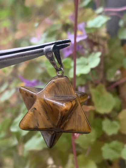 Oeil de tigre, pendentif en forme de Merkabah (ou Merkavah), de 27 millimètres de hauteur x 15 mm de largeur x 15 millimètres. Vendu avec cordon noir réglable offert !