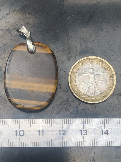 Tiger's Eye pendant measuring 42mm high x 25mm wide x 7mm thick. Comes with a free adjustable black cord!