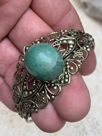 Superbe bracelet de style ancien avec cabochon d'Aventurine verte de 6,5 x 6 centimètres. Fait en Laiton couleur 'bronze', magnifique pièce fait par Gem & Zen !