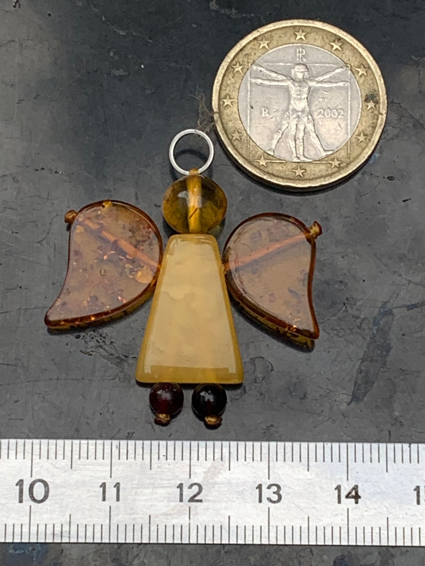 Amber, angel-shaped pendant measuring 38x35x8 millimeters, sold with a sliding (adjustable) black leather cord measuring 40 to 70 centimeters!