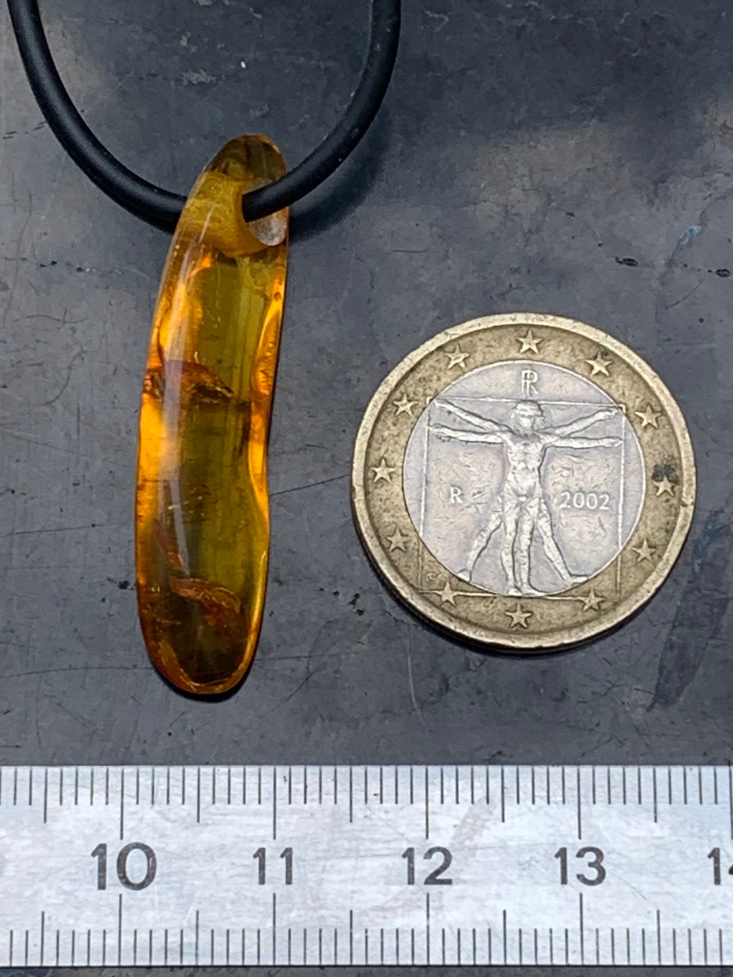 Amber, pendant measuring 40x10x6 millimeters, sold with a sliding (adjustable) black leather cord from 40 to 70 centimeters!