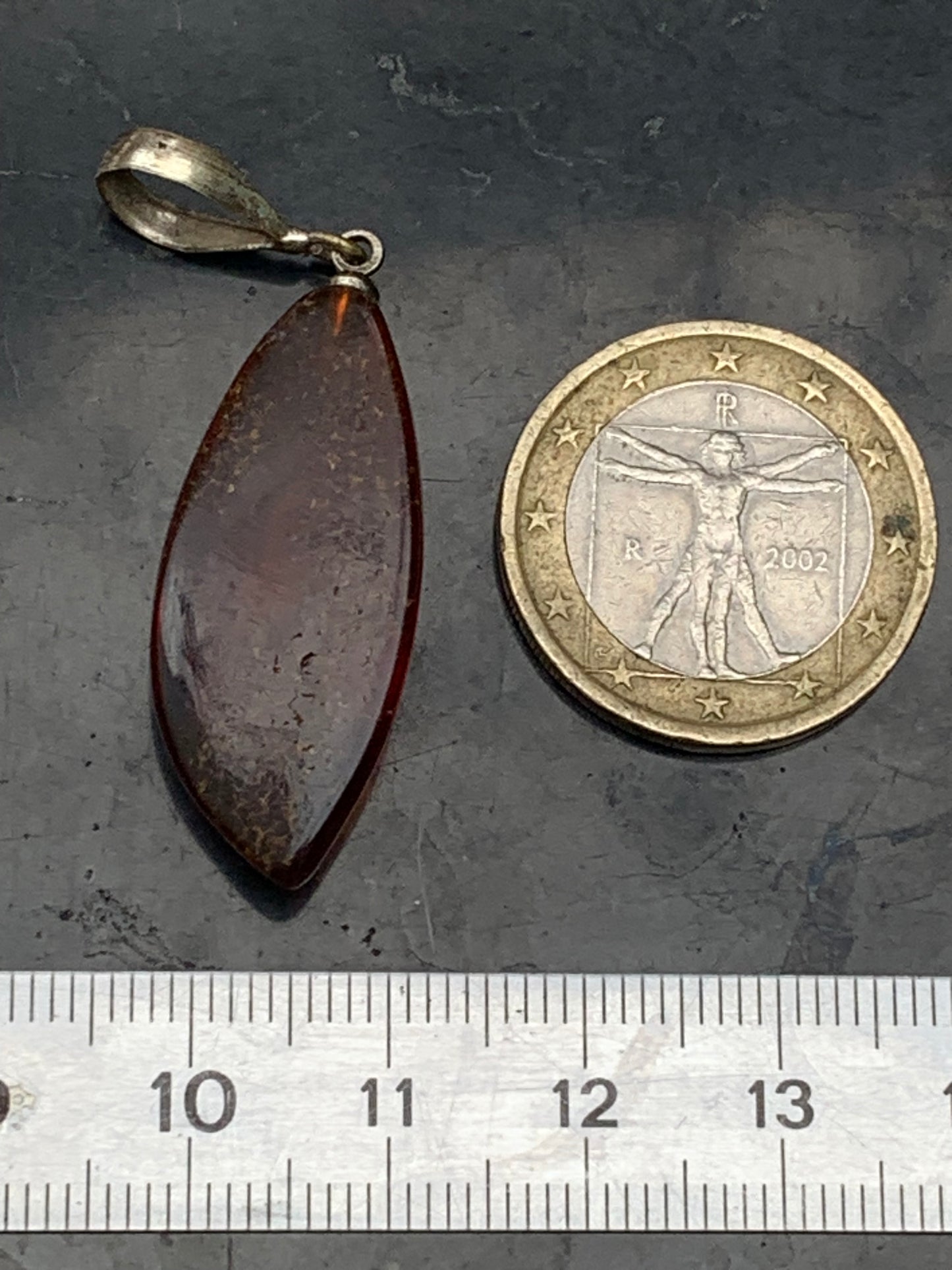 Amber, pendant measuring 40x13x9 millimeters, sold with a sliding (adjustable) black leather cord from 40 to 70 centimeters!