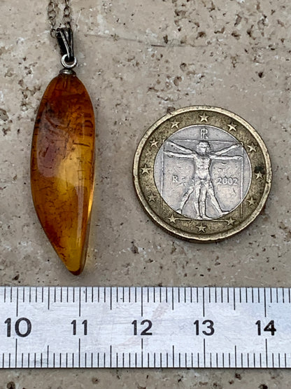 Amber, pendant measuring 40x13x9 millimeters, sold with a sliding (adjustable) black leather cord from 40 to 70 centimeters!