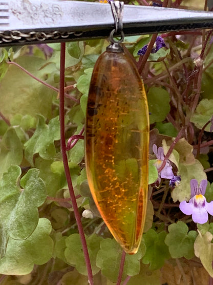 Amber, pendant measuring 40x13x9 millimeters, sold with a sliding (adjustable) black leather cord from 40 to 70 centimeters!